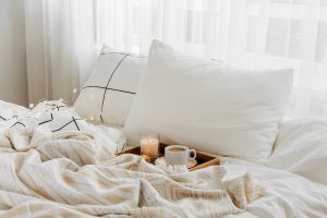 Wooden tray with coffee on a bed